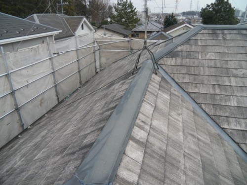 koushin_CIMG1149-1 | 外壁塗装は神奈川県横浜市の塗装職人 Rooftops with weathered gray shingles and scaffolding along the left edge; cables cross the roof peak.