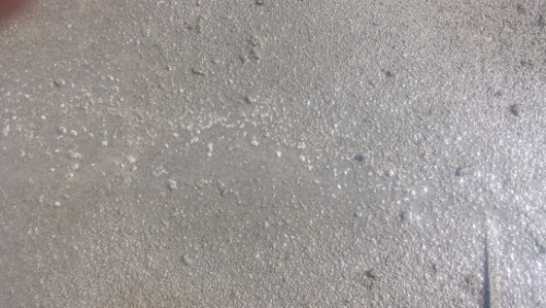 20140317 _102034 | 外壁塗装は神奈川県横浜市の塗装職人 Close-up of a wet gray concrete surface with small water droplets scattered across it.