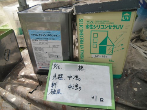 koushin_CIMG2658 | 外壁塗装は神奈川県横浜市の塗装職人 Two chemical containers on a dusty work surface, one labeled Silicone UV Finishing, with Japanese text and a handwritten note card in front.