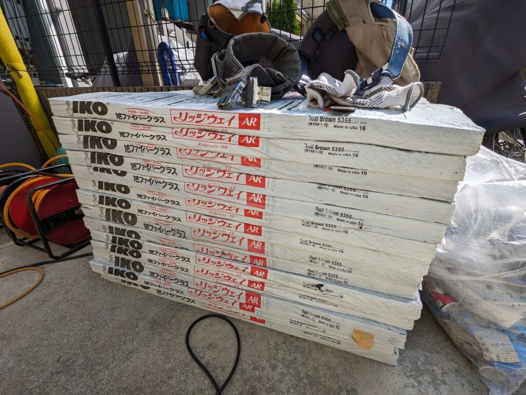 Stack of white IKO Ridgeway AR insulation boards on a construction site