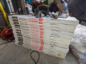 Stack of white IKO Ridgeway AR insulation boards on a construction site