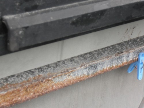 koushin_CIMG1279-1 | 外壁塗装は神奈川県横浜市の塗装職人 Blue plastic clothespin clipped to a rusty metal edge above a concrete surface.