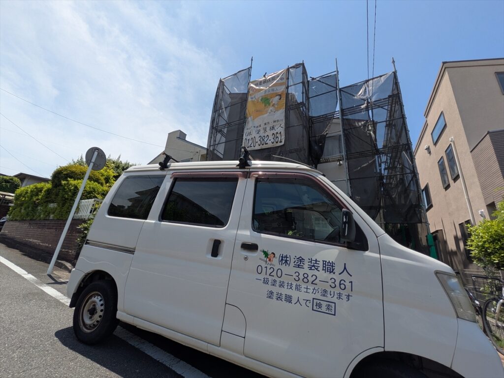 シートで囲まれた建物と前面の工事車両