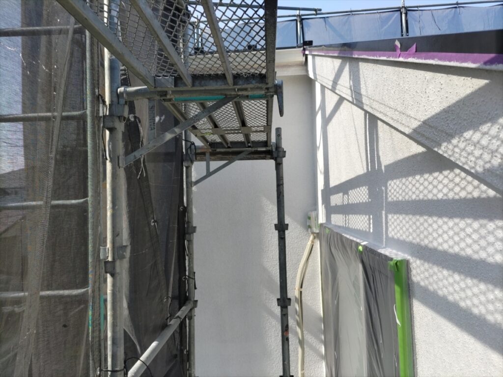 笠木の下に広がる白い壁面と養生した開口部