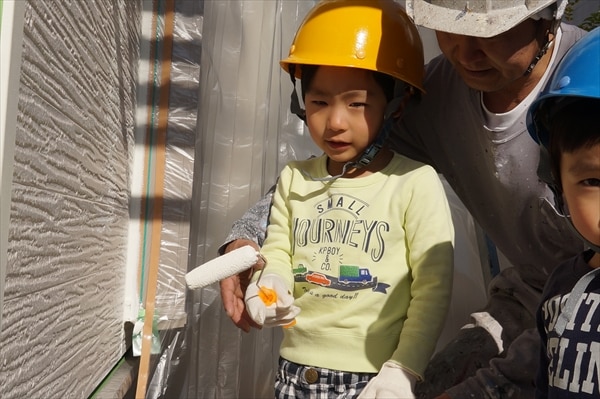 2歳と5歳の兄弟2人が大きい業者用のローラーで外壁塗装を手伝ってくれました。